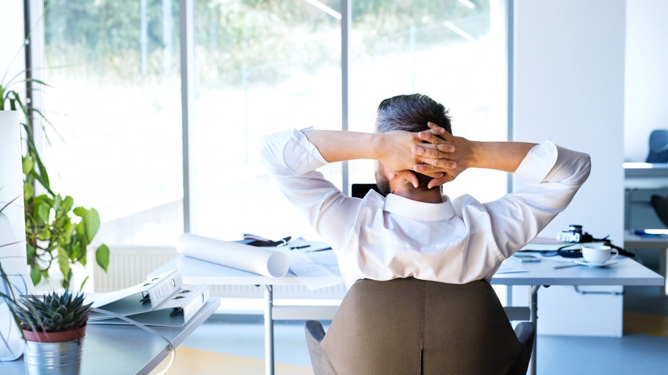 Businessman at the desk in his office resting.